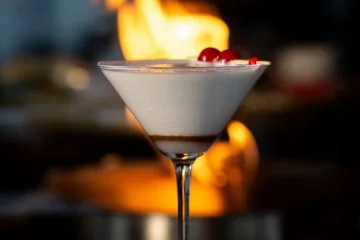 A cocktail beside the fireplace at Fiaba Brasserie