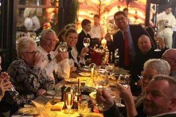 Guests gathered around a table at Fiaba Brasserie