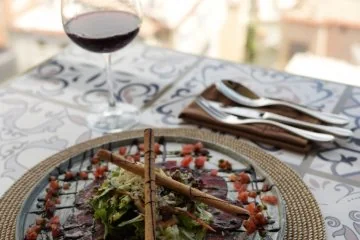 A pizza served at a window table at Fiaba Brasserie in Alanya
