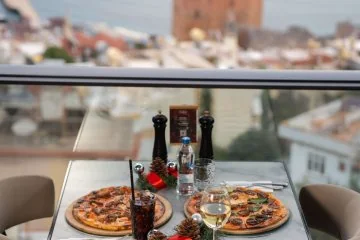 Dishes served beside the windows with an Alanya view at Fiaba Brasserie