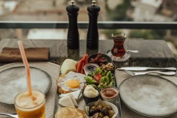 Breakfast dishes and drinks beside the windows at Fiaba Brasserie