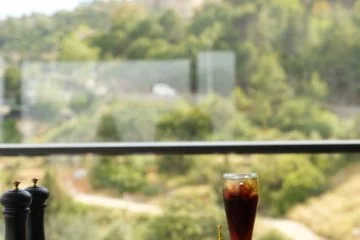 Food and drinks on a window table overlooking Alanya at Fiaba Brasserie